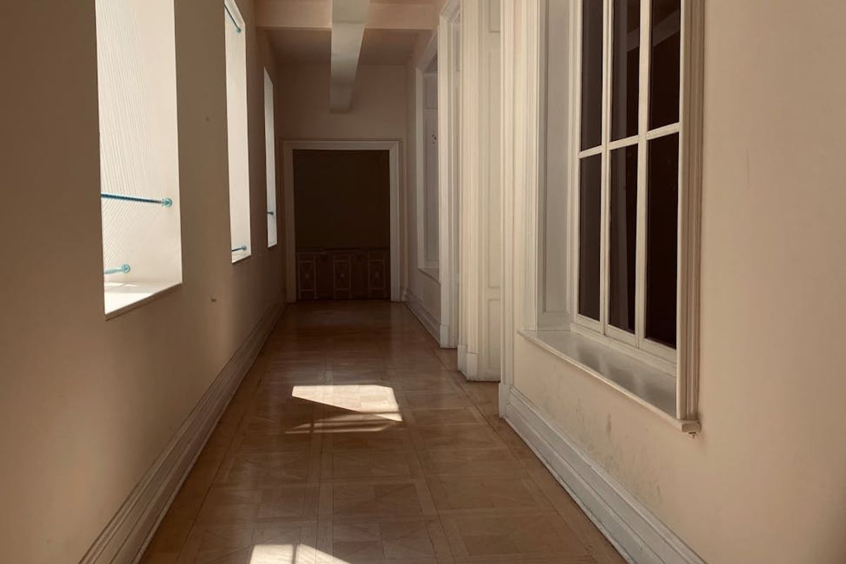 Bright minimalist training space with wooden floor and sunlight.